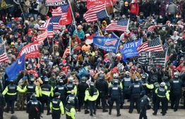 (FILES) In this file photo taken on January 06, 2021 Trump supporters clash with police and security forces as they storm the US Capitol in Washington, DC. --- Photo by Olivier Douliery/ AFP