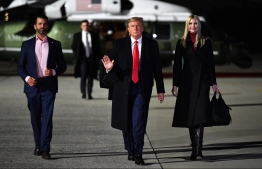 (FILES) In this file photo taken on January 04, 2021 US President Donald Trump (C), daughter Senior Advisor Ivanka Trump and son Donald Trump Jr. (L) make their way to board Air Force One before departing from Dobbins Air Reserve Base in Marietta, Georgia. - New York's top justice official has subpoenaed ex-president Donald Trump, his son Don Jr. and daughter Ivanka in her investigation into the family's business dealings, a court filing showed January 3, 2022. -- Photo: Mandel Ngan / AFP