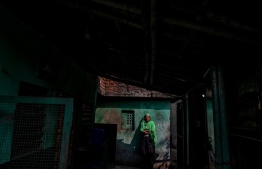 In this picture taken on December 22, 2021, Sultana Begun stands by an narrow alley next to her house in Kolkata. A destitute Indian woman who claims she is heir to the dynasty that built the Taj Mahal has demanded ownership of an imposing palace once home to the Mughal emperors. -- Photo: Dibyangshu Sarkar / AFP