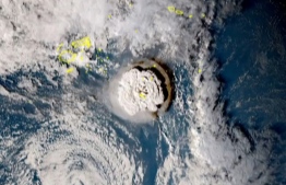 A grab taken from footage by Japan's Himawari-8 satellite and released by the National Institute of Information and Communications (Japan) on January 15, 2022 shows the volcanic eruption that provoked a tsunami in Tonga. - The eruption was so intense it was heard as "loud thunder sounds" in Fiji more than 800 kilometres (500 miles) away. Photo by Handout: National Institute of Information and Communications (JAPAN) / AFP