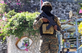 (FILES) In this file photo taken on July 07, 2021, a Haitian police officer stands guard outside of the presidential residence in Port-au-Prince, Haiti, after President Jovenel Moise was assassinated. - A former Haitian lawmaker who is a suspect in the assassination of the country's president has been arrested in Jamaica, a police source said on January 15, 2022. Ex-senator John Joel Joseph, wanted in the July 7, 2021, killing of president Jovenel Moise, was arrested overnight Friday into Saturday, the source said, without specifying where in Jamaica. (Photo: Valerrie Baeriswyl / AFP