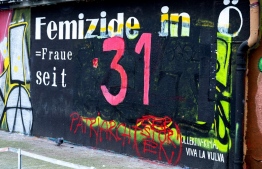 The number '31' is seen on a wall commemorating the number of femicides in Austria in 2021, in Vienna on January 17, 2022. - Painted in blood red on an improvised memorial in Vienna, the number 31 is a stark reminder of a grim toll. -- Photo: Andrea Klamar-Hutkova / AFP