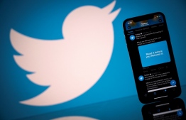 (FILES) This file photo taken on October 26, 2020 shows the logo of US social network Twitter displayed on the screen of a smartphone and a tablet in Toulouse, southern France. -- Photo:  Lionel Bonaventure / AFP