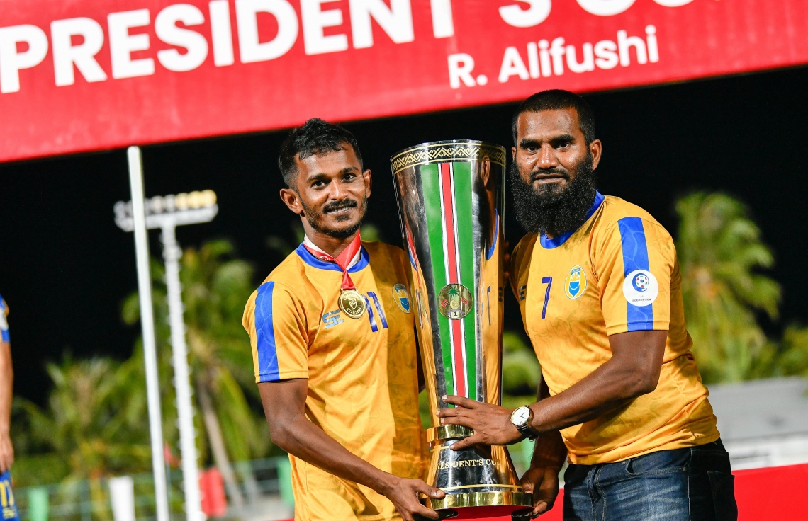 އަލިފުށި- ޖެނުއަރީ 23، 2022: ރ. އަލިފުށީގައި މިއަދު ކުޅުނު ފައިނަލް މެޗަށް ފަހު ސެންޓޭ އާއި އަޝްފާގް ޕްރެޒިޑެންޓްސް ކަޕުގެ ތަށި އުފުލާލަނީ، އިތުރު ވަގުތުގެ ދެހާފު ކުޅެ މާޒިޔާގެ މައްޗަށް 2-1 ގެ ނަތީޖާ އަކުން ކާމިޔާބު ހޯދައި ޕްރެޒިޑެންޓްސް ކަޕުގެ ޗެމްޕިއަންކަން ވެލެންސިއާއިން ވަނީ ހޯދާފައި--. ފޮޓޯ: ނިޝާން އަލީ/މިހާރު