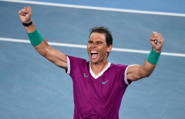 TOPSHOT - Spain's Rafael Nadal reacts after winning against Russia's Daniil Medvedev during their men's singles final match on day fourteen of the Australian Open tennis tournament in Melbourne early on January 31, 2022. -- Photo: William West / AFP
