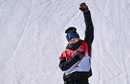 Gold medallist New Zealand's Zoi Sadowski Synnott gestures during the medals ceremony after the snowboard women's slopestyle final run during the Beijing 2022 Winter Olympic Games at the Genting Snow Park H & S Stadium in Zhangjiakou on February 6, 2022. -- Photo: Ben Stansall / AFP