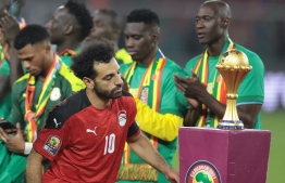 Egypt's forward Mohamed Salah walks past the trophy after loosing the Africa Cup of Nations (CAN) 2021 final football match between Senegal and Egypt at Stade d'Olembe in Yaounde on February 6, 2022. -- Photo by Kenzo Tribouillard / AFP