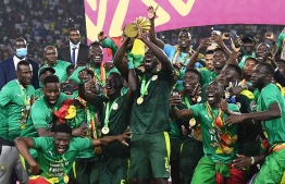 Senegal's players celebrate with the trophy after winning the Africa Cup of Nations (CAN) 2021 final football match between Senegal and Egypt at Stade d'Olembe in Yaounde on February 6, 2022. -- Photo:  Charly Triballeau / AFP