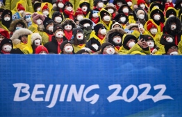Spectators watch athletes compete in the freestyle skiing men's freeski halfpipe qualification run during the Beijing 2022 Winter Olympic Games at the Genting Snow Park H & S Stadium in Zhangjiakou on February 17, 2022. -- Photo: Marco Bertorello / AFP
