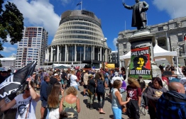Anti-vaccine demonstrators occupy the grounds surrounding the parliament building (C) in Wellington on February 22, 2022. -- Photo: Dave Lintott / AFP