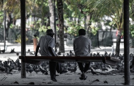 Two elderly citizens conversing with each other at Male' Artificial Beach -- Photo: Nishan Ali / Mihaaru News