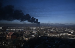 Black smoke rises from a military airport in Chuguyev near Kharkiv  on February 24, 2022. - Russian President Vladimir Putin announced a military operation in Ukraine today with explosions heard soon after across the country and its foreign minister warning a "full-scale invasion" was underway. -- Photo: Aris Messinis / AFP