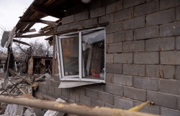 A view of a private house damaged by recent shelling in the settlement of Trudovskiye outside Donetsk on February 26, 2022. - The settlement is located around 700 meters off the contact line with Ukrainian troops. -- Photo: Viktor Antonyuk / AFP