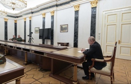 Russian President Vladimir Putin (R) meets with Defence Minister Sergei Shoigu (2L) and chief of the general staff Valery Gerasimov in Moscow on February 27, 2022. - Russian President Vladimir Putin ordered his defence chiefs to put the country's nuclear "deterrence forces" on high alert on February 27 and accused the West of taking "unfriendly" steps against his country. -- Photo: Alexey Nikolsky / SPUTNIK / AFP