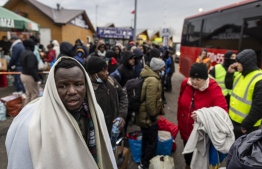 Refugees from many diffrent countries - from Africa, Middle East and India - mostly students of Ukrainian universities are seen at the Medyka pedestrian border crossing fleeing the conflict in Ukraine, in eastern Poland on February 27, 2022. - As Ukraine braces for a feared Russian invasion, its EU member neighbours are making preparations for a possible influx of hundreds of thousands or even millions of refugees fleeing military action. (Photo by Wojtek RADWANSKI / AFP)