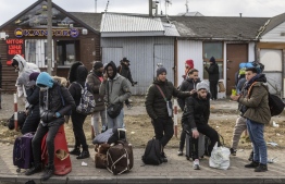 Refugees from many different countries - from Africa, Middle East and India - mostly students of Ukrainian universities are seen at the Medyka pedestrian border crossing fleeing the conflict in Ukraine, in eastern Poland on February 27, 2022. - As Ukraine braces for a feared Russian invasion, its EU member neighbours are making preparations for a possible influx of hundreds of thousands or even millions of refugees fleeing military action. (Photo by Wojtek RADWANSKI / AFP)