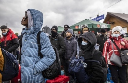 Refugees from many diffrent countries - from Africa, Middle East and India - mostly students of Ukrainian universities are seen at the Medyka pedestrian border crossing fleeing the conflict in Ukraine, in eastern Poland on February 27, 2022. - As Ukraine braces for a feared Russian invasion, its EU member neighbours are making preparations for a possible influx of hundreds of thousands or even millions of refugees fleeing military action. (Photo by Wojtek RADWANSKI / AFP)
