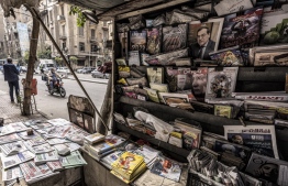 Newspapers and magazines are laid out and presented at a newsstand along Kasr al-Aini street in the centre of Egypt's capital Cairo on February 17, 2022. . -- Photo: Khaled Desouki / AFP