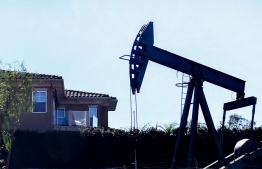 This photo taken on February 17, 2022 shows a working oil pumpjack in Signal Hill, California. - Californians filling up their cars on March 4, 2022 winced at the spiraling cost of gasoline, but largely shrugged as residents of the state that has long had the highest gas prices in the United States. California drivers are paying an average of more than $5 for a gallon ($1.34 per liter), according to the American Automobile Association (AAA), up more than a third from a year ago, as Russia's invasion of Ukraine sends world oil prices rocketing. (Photo by Frederic J. BROWN / AFP)