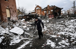 A man walks between houses destroyed during air strikes on the central Ukranian city of Bila Tserkva on March 8, 2022. - Russia stepped up its bombing campaign and missile strikes on Ukraine's cities, destroying two residential buildings in a town west of Kyiv with the city of Bila Tserkva to the south of the capital also hit. (Photo by Aris Messinis / AFP)