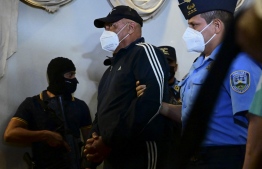 Honduran general commissioner Juan Carlos "El Tigre" Bonilla, former head of the National Police of Honduras, is escorted after being arrested for being wanted in the US for alleged drug trafficking, in Tegucigalpa, on March 9, 2022. -- Photo: Orlando Sierra / AFP