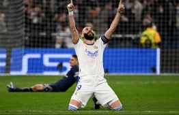 Real Madrid's French forward Karim Benzema celebrates after scoring a goal during the UEFA Champions League round of 16 second league football match between Real Madrid CF and Paris Saint-Germain at the Santiago Bernabeu stadium in Madrid on March 9, 2022. -- Photo: Gabriel Bouys / AFP
