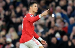 Manchester United's Portuguese striker Cristiano Ronaldo celebrates after scoring the opening goal during the English Premier League football match between Manchester United and Tottenham Hotspur at Old Trafford in Manchester, north west England, on March 12, 2022. -- Photo: Lindsey Parnaby / AFP