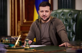 In this handout picture taken by the Ukrainian Presidency Press Office and released early on March 15, 2022, Ukrainian President Volodymyr Zelensky delivers a video address in Kyiv. -- Photo: Ukrainian Presidential Press Service / AFP