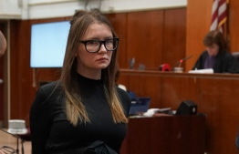 (FILES) In this file photo taken on May 9, 2019 Anna Sorokin is led away after being sentenced in Manhattan Supreme Court following her conviction last month on multiple counts of grand larceny and theft of services. - Fake heiress Anna "Delvey" Sorokin, who was jailed in 2019 for scamming hundreds of thousands of dollars from hotels, banks and friends, and who inspired a hit series on Netflix, was to be extradited to Germany on March 14, 2022, US media said. -- Photo: Timothy A. Clary / AFP