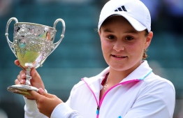 (FILES) This file photo taken on July 3, 2011 shows 15-year-old Ashleigh Barty of Australia holding the trophy after beating Russian player Irina Khromacheva during girls' singles final in the Wimbledon Tennis Championships at the All England Tennis Club in southwest London. - Three-time Grand Slam winner and world number one Ashleigh Barty stunned the tennis world on March 23, 2022 by announcing her early retirement from the sport at the age of just 25. -- Photo: Leon Neal / AFP