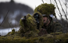 A US soldier from the 3rd Battalion, part of the 6th Marine Regiment, participates in the international military exercise Cold Response 22, at Sandstrand, North of in Norway, on March 21, 2022. - Cold Response is a Norwegian-led winter exercise in which NATO and partner countries participate. -- Photo: Jonathan Nackstrand / AFP