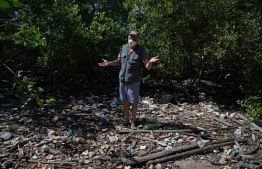 Biologist Mario Moscatelli, who runs a program to replant mangrove forests at a former dump site shows rubbish that has entered a river that flows into Guanabara Bay, in Rio de Janeiro, Brazil. Situated at the heart of Rio, Guanabara Bay is one of the most postcard-gorgeous spots on Earth, but urban sprawl has badly damaged it. Home to 12.5 million people, it has has long been a dumping ground for garbage, toxic chemicals and sewage, more than half of which goes untreated. Now, after decades of failed fixes, a new operator promises to invest billions to clean up the bay. --Photo: Carl De Souza | AFP