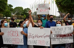Protestors hold banners and placards during a demonstration against the surge in prices and shortage of fuel and other essential commodities in Colombo on April 2, 2022. -- Photo: Ishara S. Kodikara / AFP