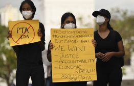 Protesters hold placards during a demonstration against the surge in prices and shortage of fuel and other essential commodities in Colombo on April 6, 2022. -- Photo: Ishara S. Kodikara / AFP