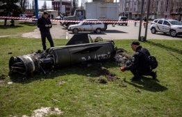 Ukrainian police inspect the remains of a large rocket with the words "for our children" in Russian next to the main building of a train station in Kramatorsk, eastern Ukraine, that was being used for civilian evacuations, that was hit by a rocket attack killing at least 35 people, on April 8, 2022. -- Photo: Fadel Senna / AFP)