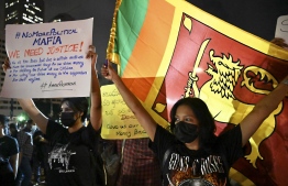 Protestors take part in a demonstration against the economic crisis at the entrance of the president's office in Colombo on April 11, 2022. Sri Lanka's Prime Minister Mahinda Rajapaksa pleaded for "patience" as thousands continued to take to the streets to protest his family's rule, with public anger at a fever pitch over the country's crippling economic crisis. -- Photo: by Ishara S. Kodikara / AFP
