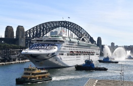 The Pacific Explorer makes its way to dock at the overseas passenger terminal on Sydney Harbour on April 18, 2022, as Australian authorities lifted a ban on cruise ships after relaxation in Covid 19 restrictions. -- Photo: Saeed Khan / AFP
