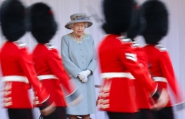 (FILES) In this file photo taken on June 12, 2021 Britain's Queen Elizabeth II watches a military ceremony to mark her official birthday at Windsor Castle, in Windsor. - Gun salutes will ring out Thursday to mark Queen Elizabeth II's 96th birthday, although the monarch herself was expected to mark the occasion with little fanfare. -- Photo: Chris Jackson / POOL / AFP