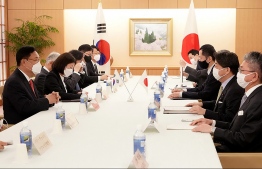 This handout picture taken on April 25, 2022 and provided by the Ministry of Foreign Affairs of Japan shows Chung Jin-suk (L), deputy speaker of South Korea's National Assembly and the head of a delegation sent by South Korean President-elect Yoon Suk-yeol to Japan, speaking with Japan's Foreign Minister Yoshimasa Hayashi (2nd R) during their meeting at the Foreign Ministry in Tokyo. -- Photo by Handout / Ministry of Foreign Affairs of Japan / AFP