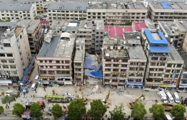 This aerial photograph taken on April 29, 2022 shows rescuers working after a six-storey building collapsed in Changsha, in China's central Hunan province. (Photo by CNS / AFP) / 
