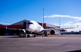 An Airbus A350-1000 aircraft is parked on the tarmac at Sydney international airport on May 2, 2022, to mark a major fleet announcement by Australian airline Qantas. - Qantas announced on May 2 it will launch the world's first non-stop commercial flights from Sydney to London and New York by the end of 2025, finally conquering the "tyranny of distance". -- Photo: Wendell Teodoro / AFP