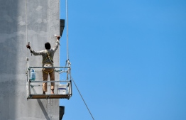 A worker amid construction and development of a residential building in Hulhumale' 2
