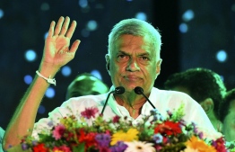 (FILES) In this file photo taken on August 02, 2020 United National Party (UNP) party leader Ranil Wickremesinghe waves to supporters during the party's final campaign rally ahead of the upcoming parliamentary elections in Colombo. PM insisted on leading the finance ministry himself, a politician involved in the negotiations had informed AFP. -- Photo: Ishara S. Kodikara / AFP
