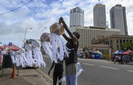Anti-government demonstrators decorate a street near the President's office during the Vesak festival in Colombo on May 15, 2022. - Sri Lankan authorities lifted a nationwide curfew on May 15 for an important Buddhist festival, with celebrations muted as the island weathers a worsening economic crisis. -- Photo: Ishara S. Kodikara / AFP