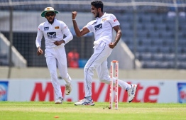Sri Lanka's Kasun Rajitha (R) celebrates after bowing out Bangladesh's Najmul Hossain Shanto (not pictured) during the first day of the second Test cricket match between Bangladesh and Sri Lanka at the Sher-e-Bangla National Cricket Stadium in Dhaka on May 23, 2022. -- Photo: Munir uz Zaman / AFP