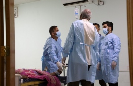 Doctors at a hospital in Iraq's southern Dhi Qar province, examine a patient infected with the tick-borne virus Crimean-Congo haemorrhagic illness (CCHF), on May 25, 2022, during the country's worst detected outbreak of the illness. - The CCHF virus has no vaccine and onset can be swift, with a victim suffering from severe bleeding, both internally as well as externally and especially from the nose. It causes death in as many as two-fifths of cases, according to medics. -- Photo: Asaad Niazi / AFP