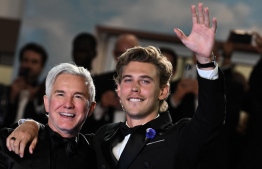 (FILES) In this file photo taken on May 25, 2022 Australian director Baz Luhrmann (L) and US actor Austin Butler pose before leaving the Festival Palace following the screening of the film "Elvis" during the 75th edition of the Cannes Film Festival in Cannes, southern France. - "After the shooting, I had an existential crisis": not surprising for Austin Butler, who spent almost three years in the skin of Elvis for the biopic on the "King", presented in Cannes, which he is the revelation. (Photo by CHRISTOPHE SIMON / AFP)