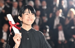 Japanese director Chie Hayakawa poses during a photocall after she won a special mention for the film "Plan 75" during the closing ceremony of the 75th edition of the Cannes Film Festival in Cannes, southern France, on May 28, 2022. (Photo by LOIC VENANCE / AFP)