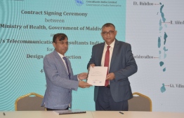 Minister of State for Health Ahmed Adil (R) and Executive Director of TCIL  Atul Kumar Jain holds upagreement signed between them to build hospitals in four islands in Maldives, on May 30 -- Photo: Health Ministry