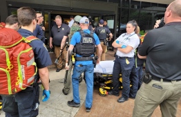 In this handout photo courtesy of Tulsa Police Department taken on June 1, 2022, Police officers and emergency personnel respond to a call about a man armed with a rifle at the Natalie Building at St. Francis Hospital in Tulsa, Oklahoma. -- Photo: Tulsa Police Department / AFP